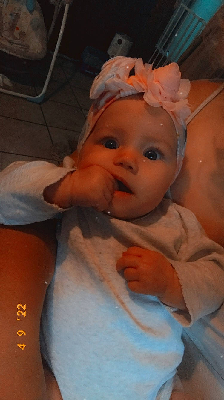 Katie is registered to the contest to win money with this photo: baby, baby_toddler_clothing, cheek, child, chin, comfort, ear, eye, eyebrow, eyelash, fun, happy, headgear, headpiece, headwear, iris, lip, mouth, nose, person