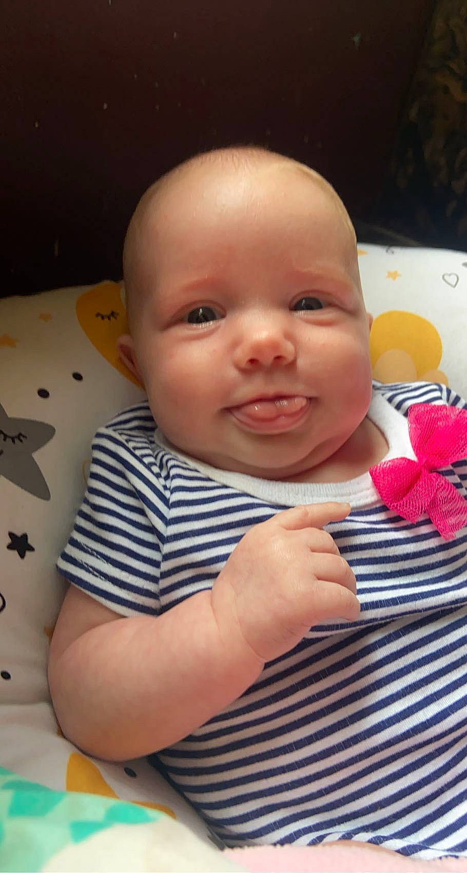 Katie is registered to the contest to win money with this photo: baby, baby_toddler_clothing, cheek, chin, comfort, facial_expression, fun, gesture, happy, head, iris, lip, mouth, nose, people, person, skin, sleeve, smile, thumb