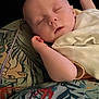 baby, sleeping, blanket, bed, bedding, cartoon, animal_prints, child, peaceful, cozy, infant, cute, soft, resting, pillow, comfort, indoors, young, portrait, relaxation