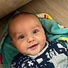 Lawton is registered to the contest to win money with this photo: baby, blanket, child, clothing, cozy, cute, expression, eyes, face, floor, hand, happy, head, indoor, infant, person, portrait, smiling, toddler, young