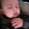 baby, camo_clothing, child, closeup, cozy, cute, eyelashes, face, hand, indoors, infant, peace, peaceful, pillow, portrait, resting, skin, sleeping, soft_lighting, young