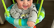 Lawton joined the competition — help win amazing prizes! baby, child, smiling, indoor, swing, jumper, happy, face, clothing, socks, floor, ropes, toy, person, cute, infant, playtime, bright_colors, wood_floor, home