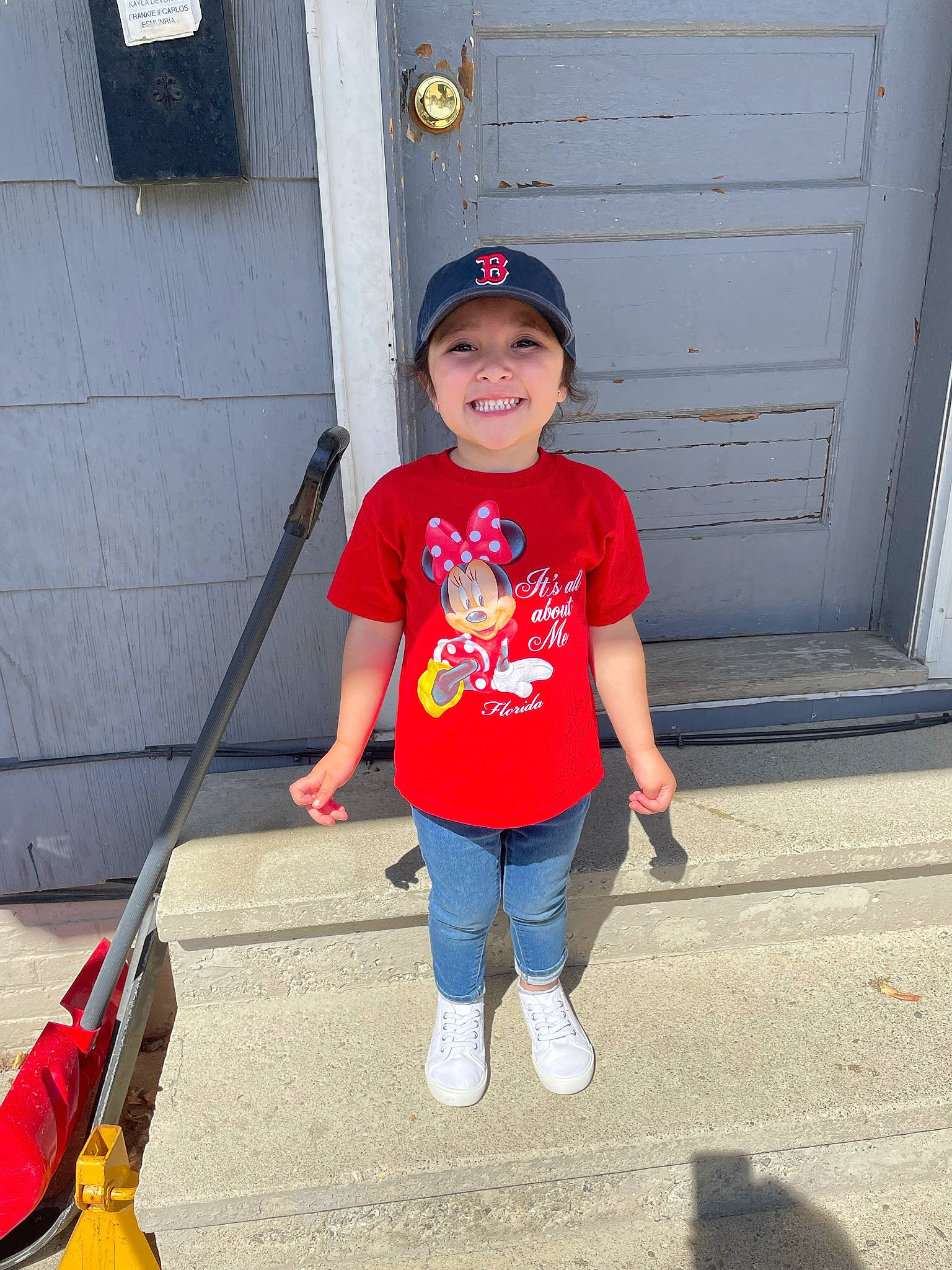 Frankie is registered to the contest to win money with this photo: baseball_cap, cap, cool, door, electric_blue, fun, happy, hat, headwear, human_body, jeans, joy, knee, leg, line, person, red, sleeve, smile, standing