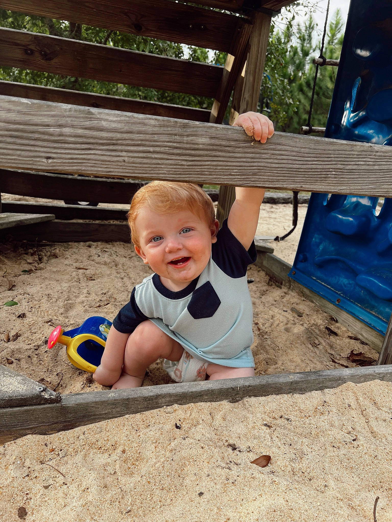 Dutton Riggs joined the competition — help win amazing prizes! baby, baby_toddler_clothing, child, city, flooring, fun, grass, happy, joy, landscape, leisure, outdoor_play_equipment, person, play, recreation, sitting, smile, soil, t_shirt, toddler