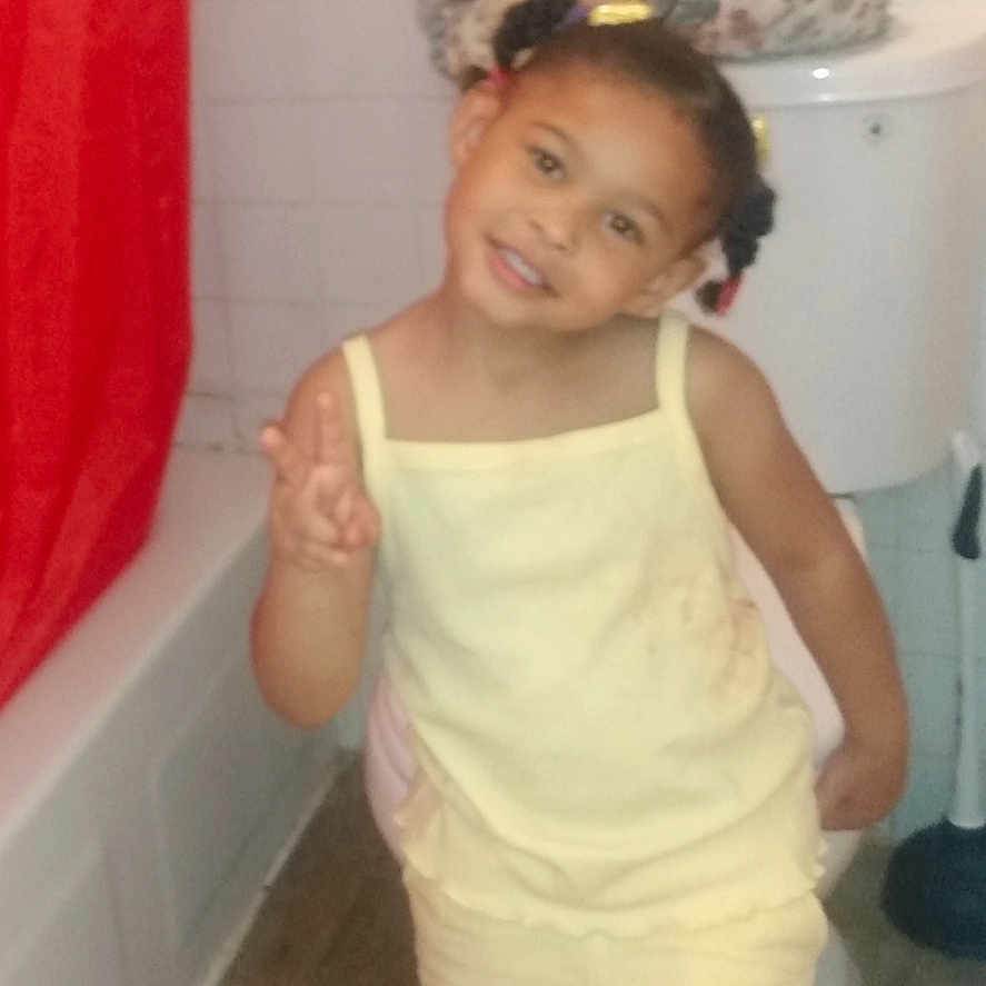 Royalty joined the competition — help win amazing prizes! child, girl, yellow_clothing, bathroom, red_shower_curtain, toilet, bath_mat, peace_sign, smile, tile_wall, floor, hair_buns, portrait, indoor, person, cute, happy, playful, casual, home