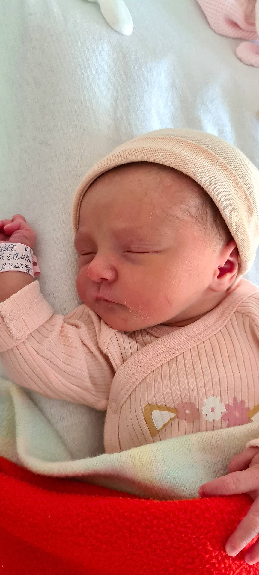 baby, beanie, blanket, bodypart, bonnet, cap, clothing, face, finger, furniture, hand, hat, head, knitwear, newborn, person, photography, portrait, sleeping, sweater