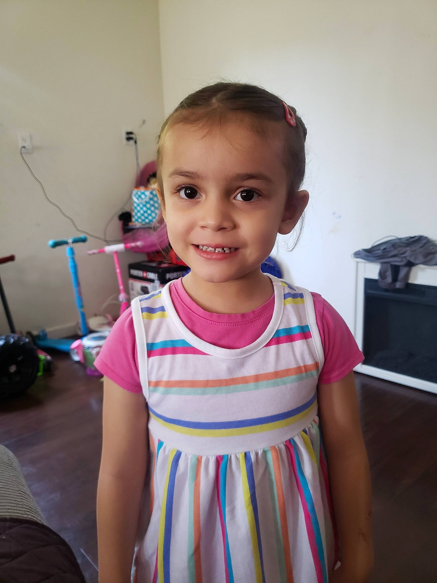 Lianna is registered to the contest to win money with this photo: arm, baby, cheek, child, dress, eye, face, forehead, head, iris, joint, joy, neck, person, pink, room, shoulder, skin, smile, standing