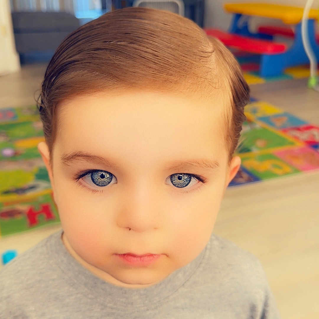 Jeff joined the competition — help win amazing prizes! background, blue_eyes, casual_clothing, child, colorful, cute, daylight, expression, face, floor, hair, indoor, kid, person, playroom, portrait, serious, toy, tshirt, young_boy