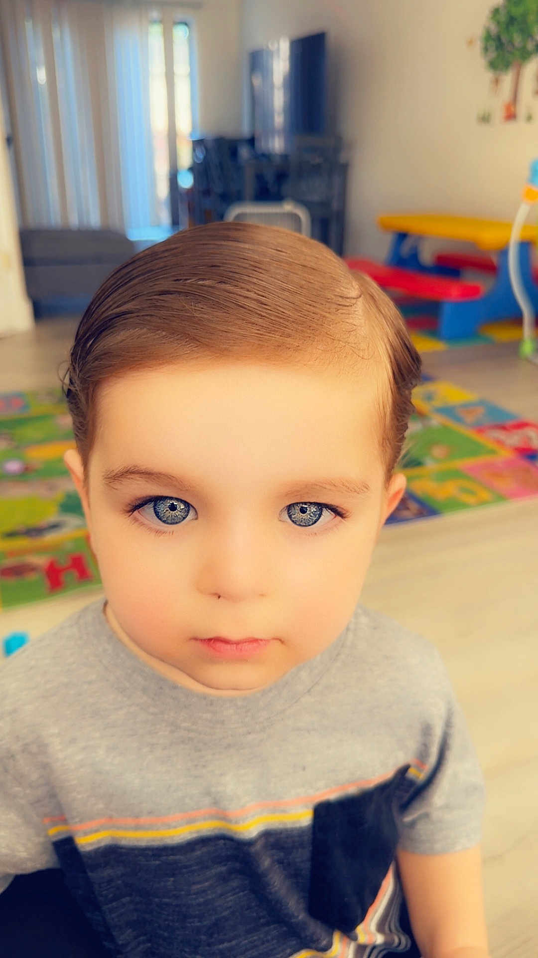 Jeff joined the competition — help win amazing prizes! child, portrait, indoor, blue_eyes, hair, tshirt, playroom, colorful, young_boy, face, expression, casual_clothing, floor, background, toy, daylight, person, cute, serious, kid