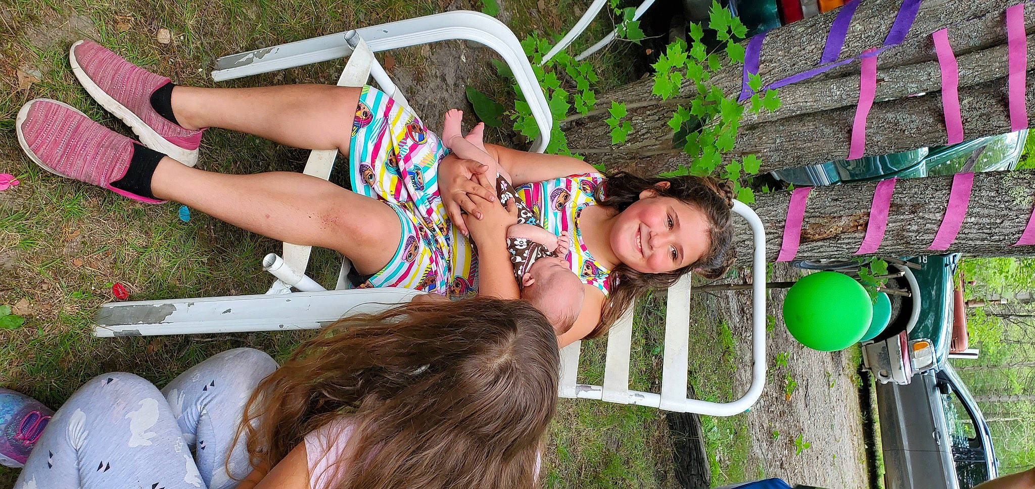 Kae-jay joined the competition — help win amazing prizes! balloon, barefoot, fun, grass, green, hair, hairstyle, happy, human_leg, joy, knee, leisure, people_in_nature, person, plant, recreation, sandal, sitting, swimsuit_top, swimwear