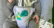 Connor joined the competition — help win amazing prizes! baby, baby_bouncer, child, comfort, cute, fabric, foot, grey_clothing, hand, hoodie, indoors, infant, nap, patterned, relaxed, seated, sleepy, toy_book, turtle_print, yawning