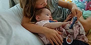 Lilly joined the competition — help win amazing prizes! child, baby, sibling, bed, blanket, pillow, window, curtain, indoor, device, handheld, kissing, caring, clothing, person, room, playing, cute, family, love