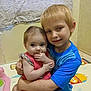 Lilly is registered to the contest to win money with this photo: baby, child, boy, infant, hugging, indoor, playmat, colorful, cute, smiling, sitting, clothing, person, family, toddler, young, floor, blanket, portrait, affection