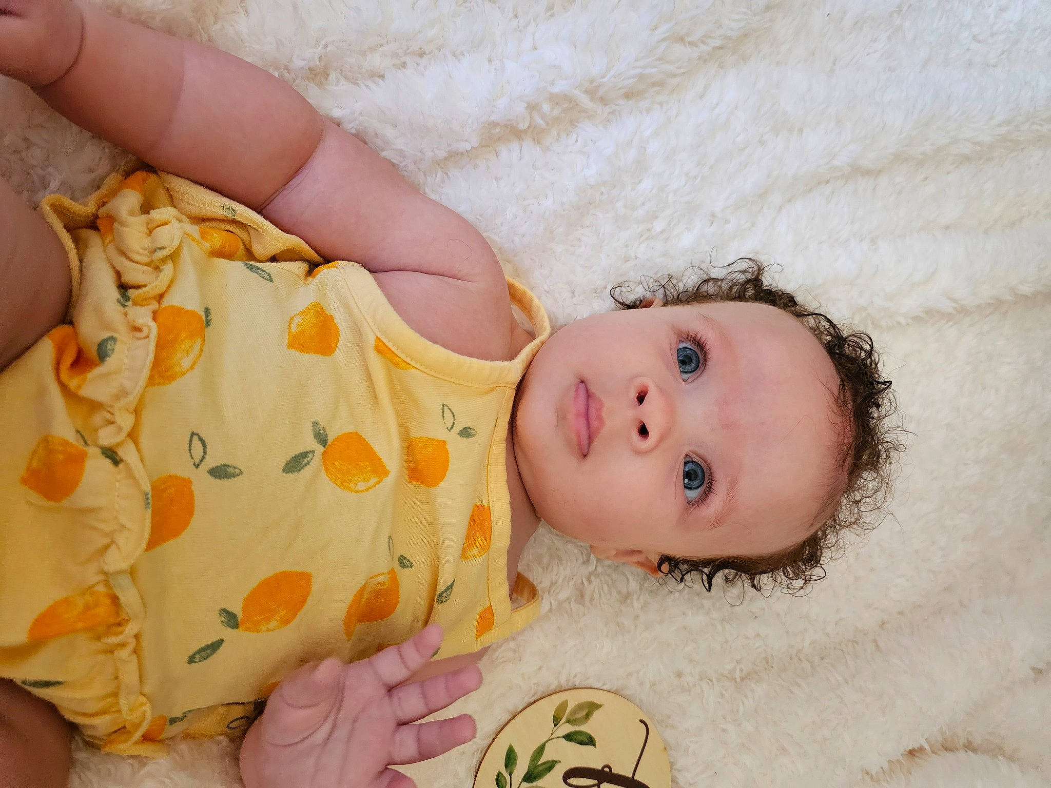 Raine is registered to the contest to win money with this photo: arm, baby, baby_toddler_clothing, cheek, child, comfort, dress, eye, face, finger, hand, happy, leg, mammal, nail, pattern, person, product, skin, textile