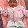 baby, newborn, sleeping, pink, knitted_cardigan, hat, pom_pom, white_pants, hearts_pattern, blanket, star_pattern, soft, cozy, infant, cute, clothing, footwear, lying_down, peaceful, child