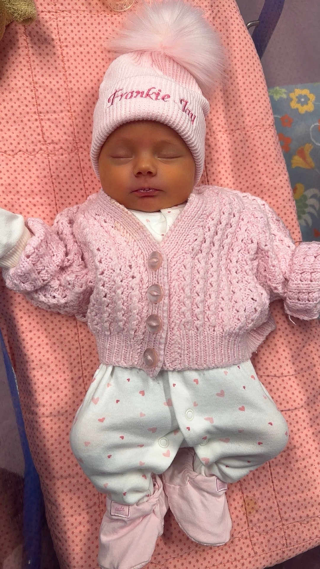Frankie Jay joined the competition — help win amazing prizes! baby, newborn, sleeping, pink, knitted_cardigan, hat, pom_pom, white_pants, hearts_pattern, blanket, star_pattern, soft, cozy, infant, cute, clothing, footwear, lying_down, peaceful, child