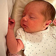 Frankie is registered to the contest to win money with this photo: newborn, baby, sleeping, infant, onesie, polka_dot, heart, blanket, soft, cozy, closeup, face, skin, peaceful, resting, indoors, child, cute, portrait, young