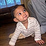 baby, child, crawling, indoor, floor, wooden_floor, sweater, striped_clothing, person, smiling, curious, looking_up, adult, sweatpants, sofa, window, curtains, home, cozy, flooring
