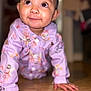 baby, child, crawling, floor, wooden_floor, onesie, lavender, floral_pattern, cute, indoors, portrait, smiling, happy, hands, face, person, closeup, infant, expression, home