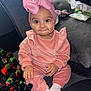 Amriah Jasmine is registered to the contest to win money with this photo: baby, blanket, bow, child, couch, cozy, cute, expression, footwear, hand, headband, home, indoor, infant, pink_clothing, plush_toy, portrait, sitting, smile, soft_fabric