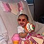Amriah Jasmine is registered to the contest to win money with this photo: baby, banner, blanket, celebration, child, cute, decorations, fun, happy, indoor, party_hat, pink_tutu, portrait, smiling, sunglasses, tassels, toy_cake, toy_dessert, toy_ice_cream, toy_popcorn