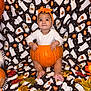 baby, pumpkin, headband, orange, halloween, ghost_pattern, blanket, autumn_leaves, fall, cute, infant, festive, costume, sitting, child, smile, holiday, decor, seasonal, indoors