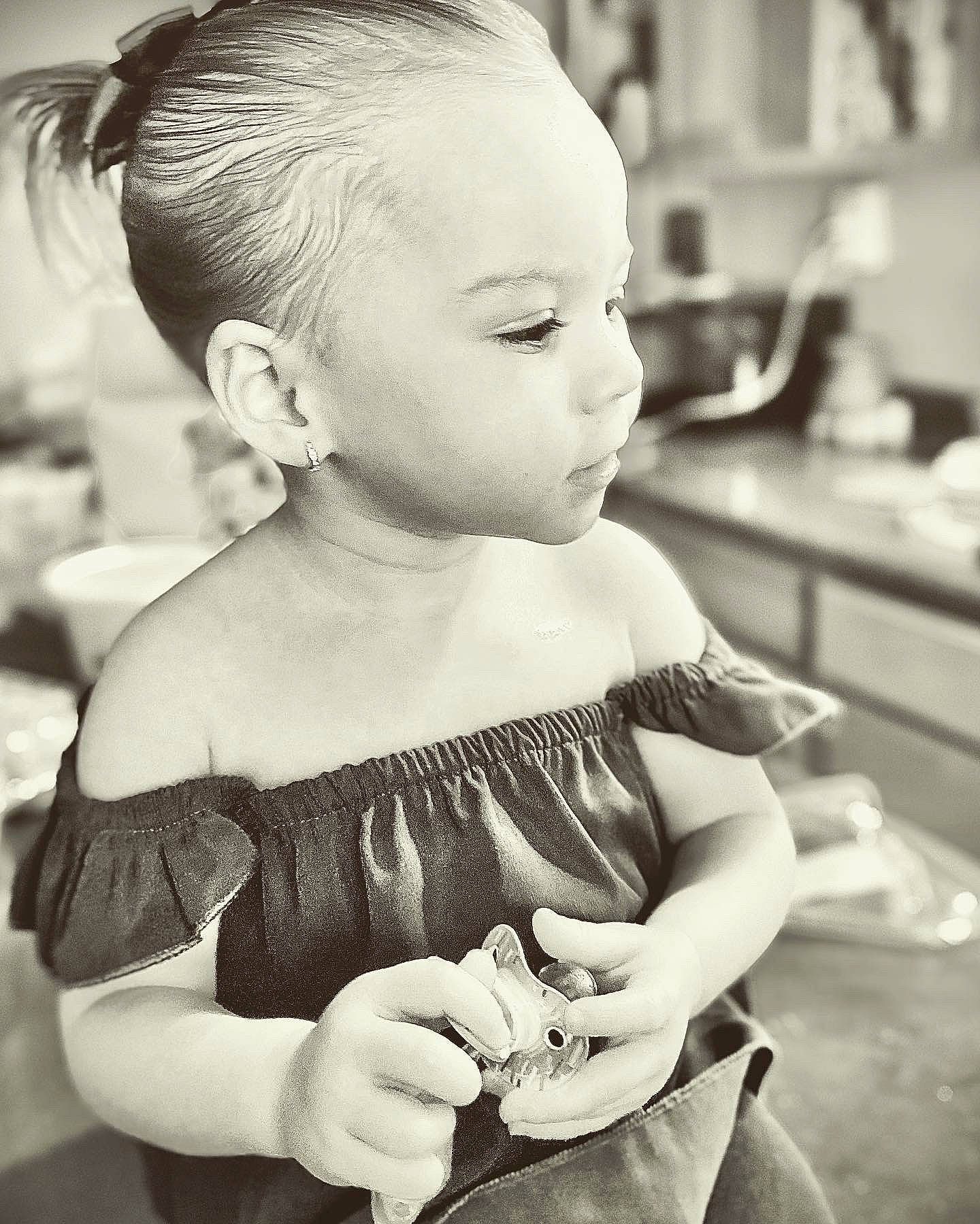 Lylah is registered to the contest to win money with this photo: arm, baby_toddler_clothing, black, black_and_white, dress, ear, eyelash, hair, hairstyle, hand, happy, head, iris, monochrome, neck, person, photograph, shoulder, skin, style