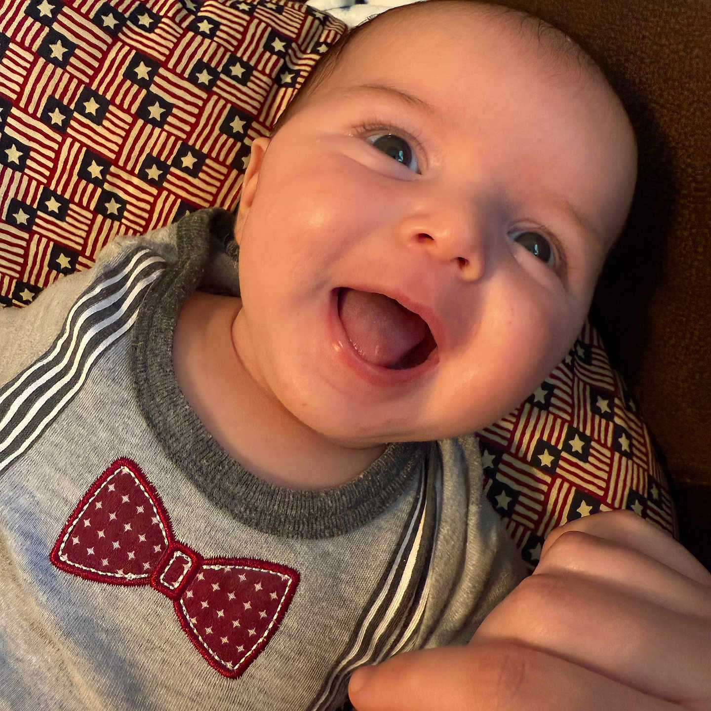 James joined the competition — help win amazing prizes! accessories, baby, babylaughing, bodypart, clothing, couch, cushion, face, finger, furniture, hand, happy, head, homedecor, laughing, person, photography, portrait, smile, t_shirt