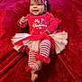 Ki'Mani joined the competition — help win amazing prizes! baby, infant, smile, christmas, holiday, red_clothing, headband, bow, tutu, striped_leggings, feet, happy, portrait, celebration, festive, blanket, cute, child, toddler, lying_down