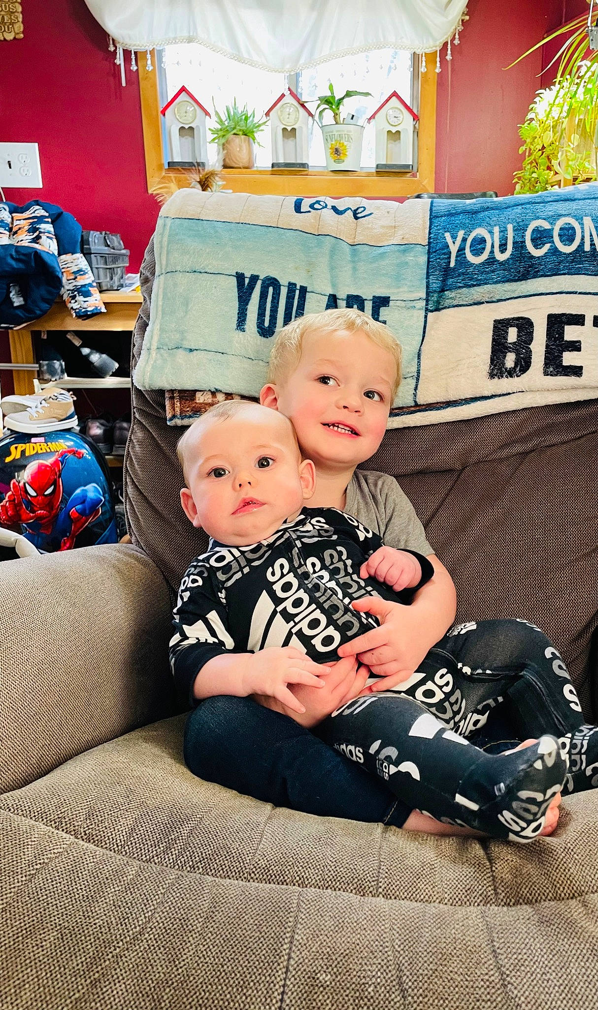 Elliot is registered to the contest to win money with this photo: baby, baby_products, baby_toddler_clothing, child, couch, fun, happy, joy, logo, pattern, person, personal_protective_equipment, product, room, sitting, smile, sock, t_shirt, toddler