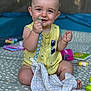 baby, beads, blanket, candid, child, comfort, cute, face, foot, hand, happy, indoors, infant, pacifier, playmat, portrait, sitting, smiling, toy, yellow_clothing