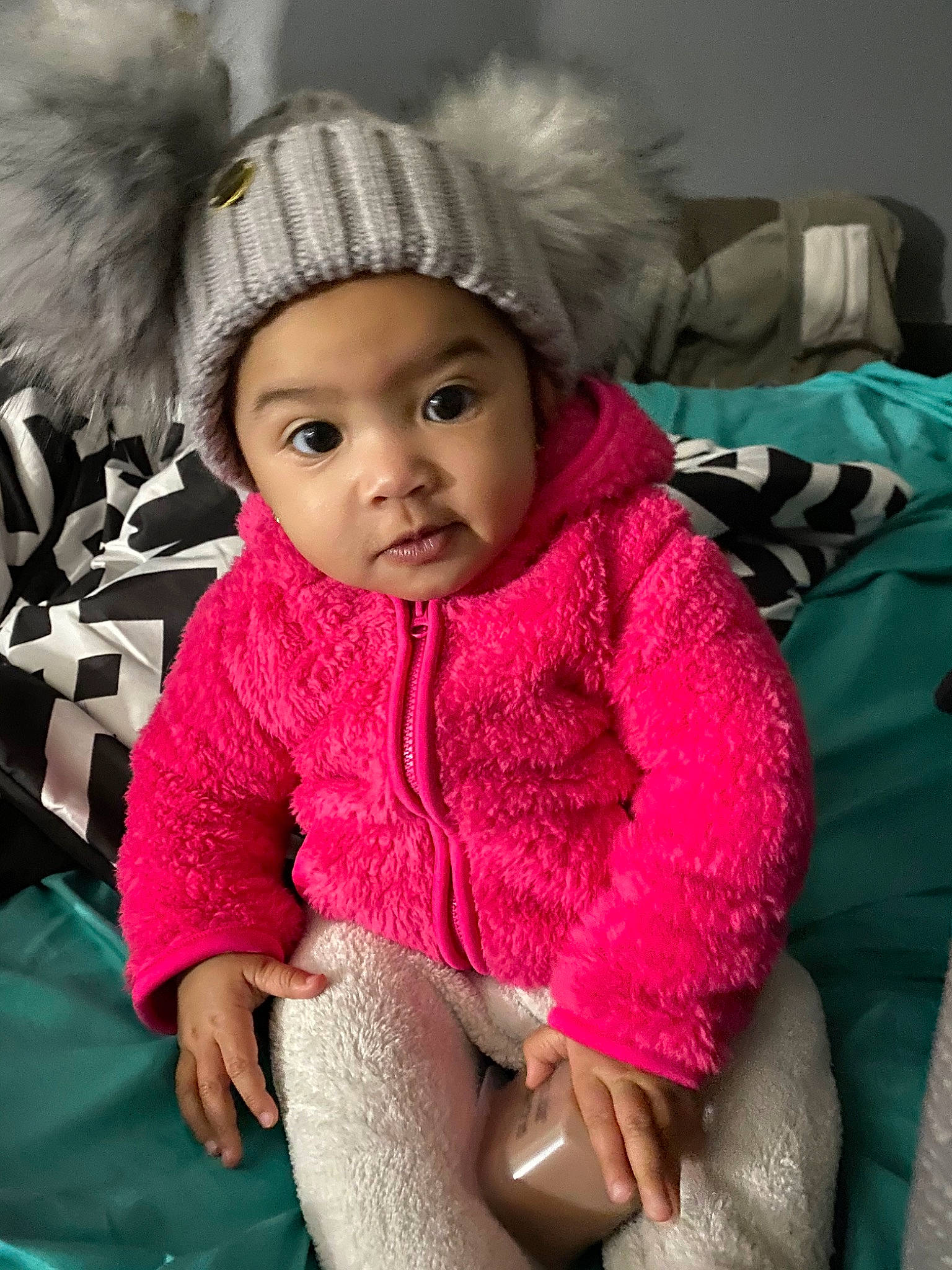 Emani is registered to the contest to win money with this photo: baby, cheek, child, clothing, fur, headgear, headwear, knit_cap, knitting, magenta, outerwear, person, pink, skin, smile, toddler, wool