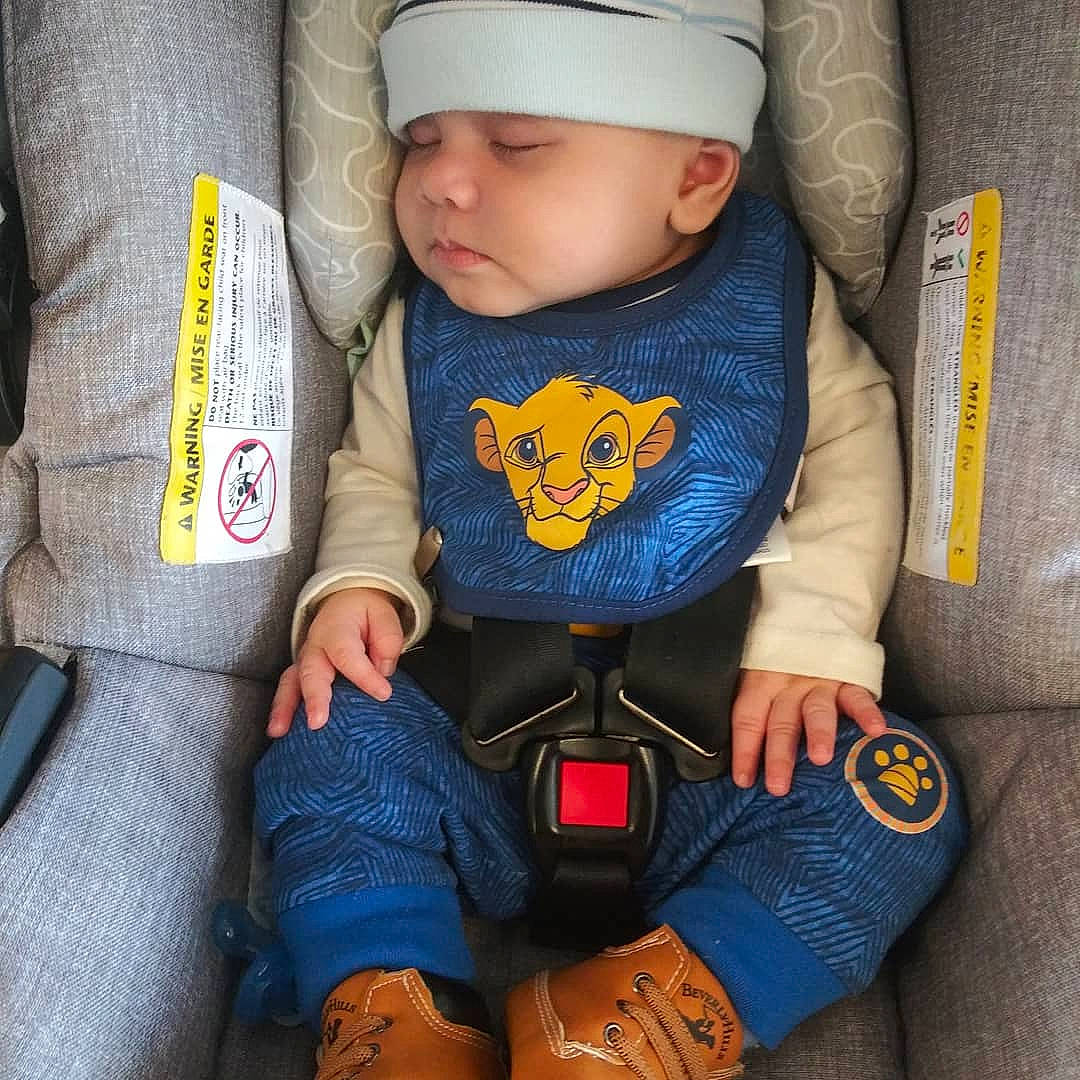 Alec is registered to the contest to win money with this photo: baby, baby_in_car_seat, baby_products, baby_safety, baby_sleeping, baby_toddler_clothing, bonnet, child, comfort, denim, headwear, outdoor_shoe, person, toddler, walking_shoe