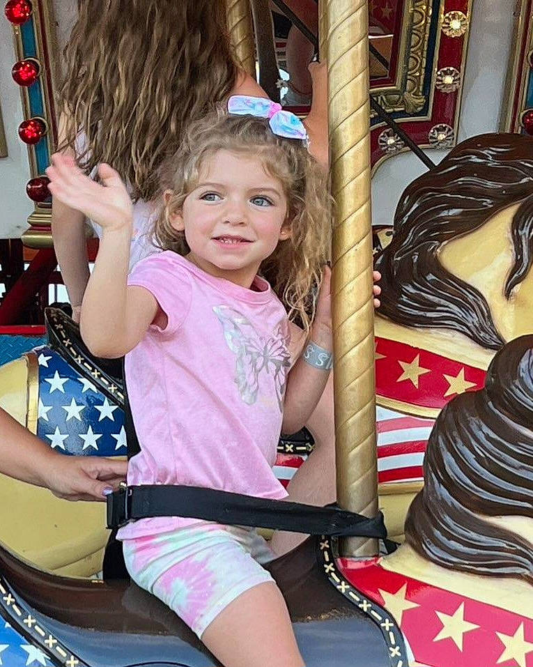 Marissa is registered to the contest to win money with this photo: amusement_ride, chin, cool, eye, facial_expression, fun, hairstyle, happy, head, human_body, joy, leisure, organ, person, pink, playground, public_space, recreation, skin, smile