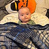 Rowan joined the competition — help win amazing prizes! baby, blanket, bed, pillow, orange, plaid, pumpkin, child, face, expression, cozy, indoor, soft, cute, sleeping_area, animal_print, comfort, warm, toddler, smiling