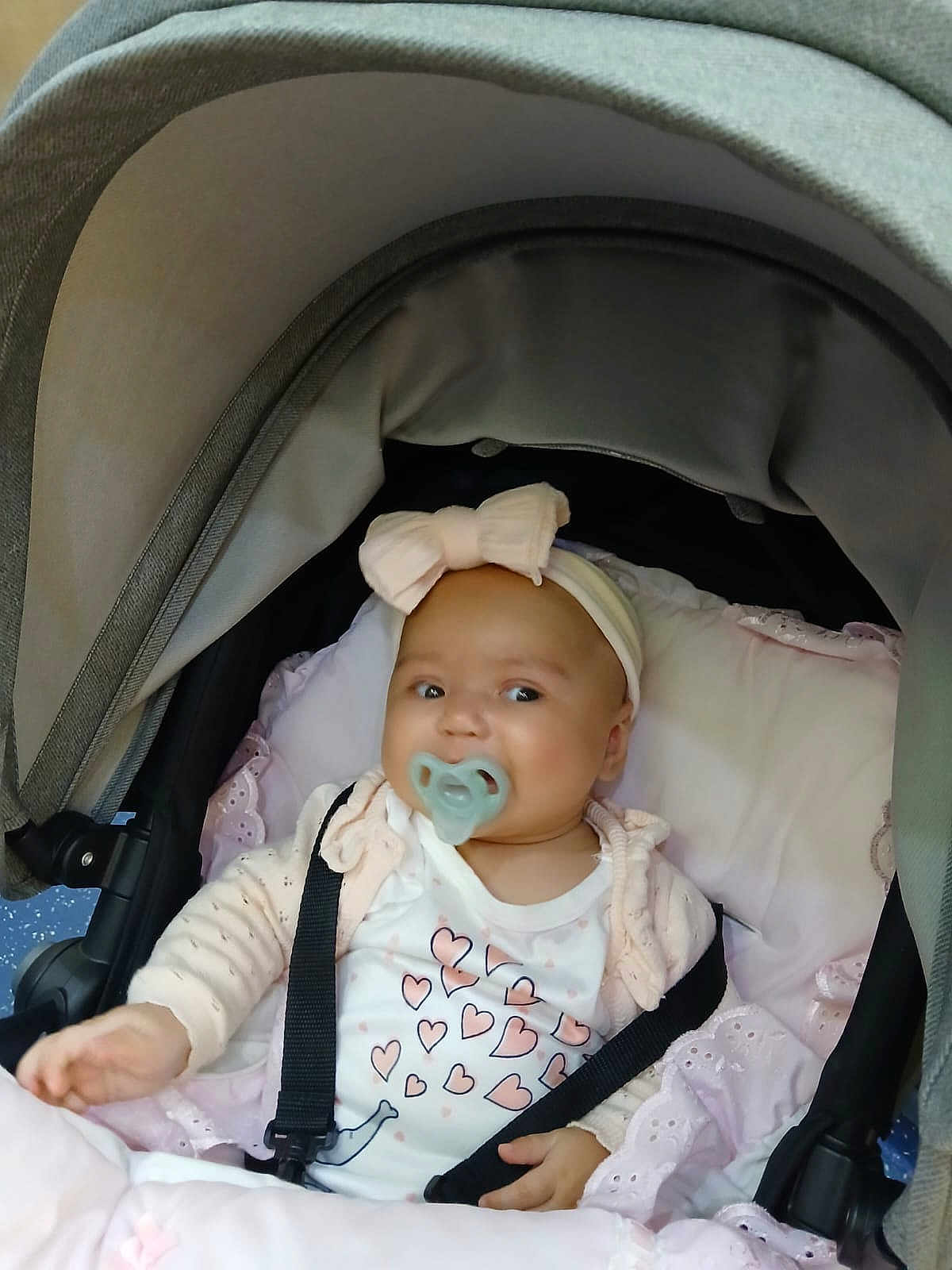 Isla Rose joined the competition — help win amazing prizes! baby, pacifier, bow, headband, stroller, blanket, infant, child, clothing, heart_pattern, seatbelt, cute, indoors, pink, white, soft, portrait, baby_girl, comfort, resting