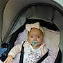 Isla Rose is registered to the contest to win money with this photo: baby, pacifier, stroller, pink_bow, blanket, infant, child, cute, clothing, seatbelt, pink, white, face, headwear, baby_girl, indoor, portrait, baby_carrier, soft_toys, baby_clothes