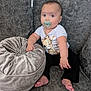 baby, pacifier, couch, cushion, infant, child, clothing, sitting, indoors, cute, giraffe_print, barefoot, plush, face, expression, person, furniture, comfort, home, relaxation