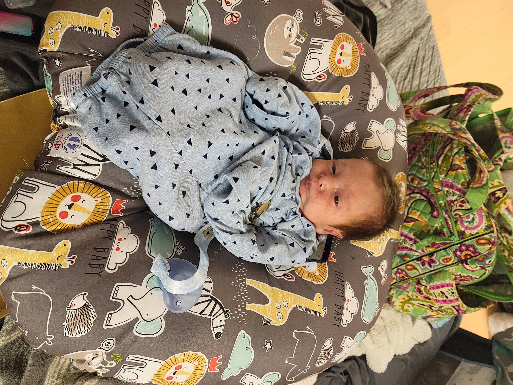 Christopher is registered to the contest to win money with this photo: baby, baby_products, baby_toddler_clothing, bedding, child, comfort, head, human_body, linens, nap, pajamas, pattern, person, room, sitting, sleeve, t_shirt, textile, toddler, visual_arts