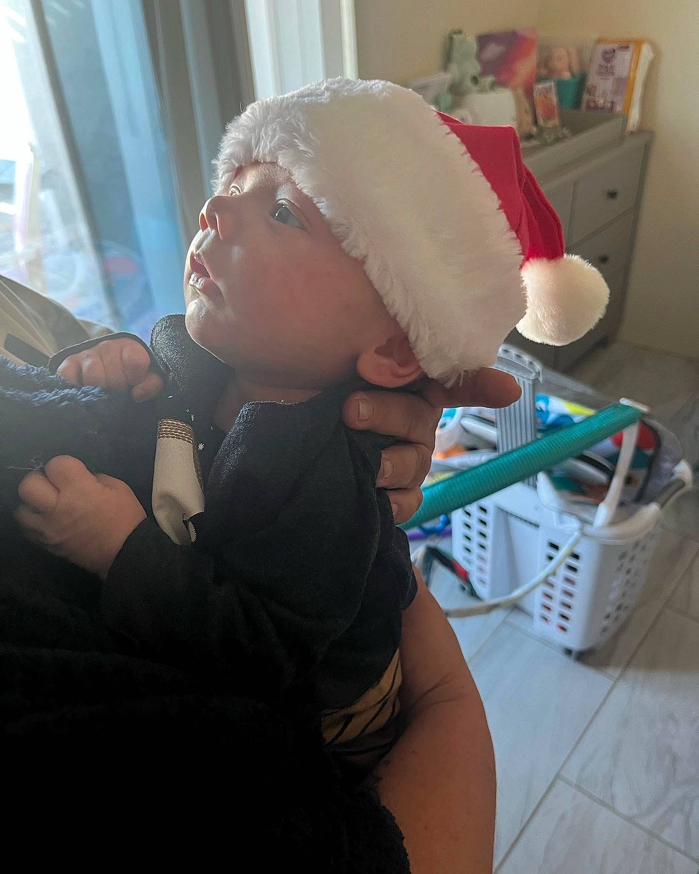 Luke is registered to the contest to win money with this photo: baby, box, cap, child, comfort, event, eyewear, fun, fur, headwear, holiday, lap, person, room, sitting, toddler