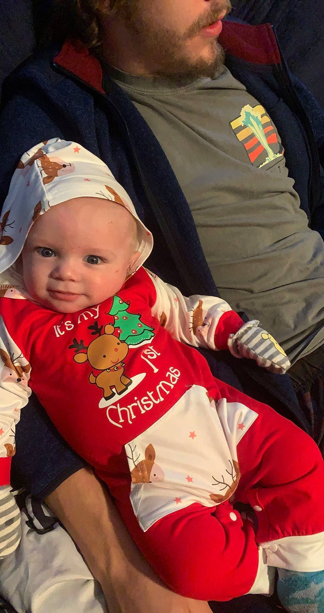 Tracy is registered to the contest to win money with this photo: baby, baby_products, baby_toddler_clothing, cap, carmine, child, elbow, event, fashion_accessory, happy, headwear, human, human_body, human_leg, lap, person, sitting, sleeve, smile, t_shirt