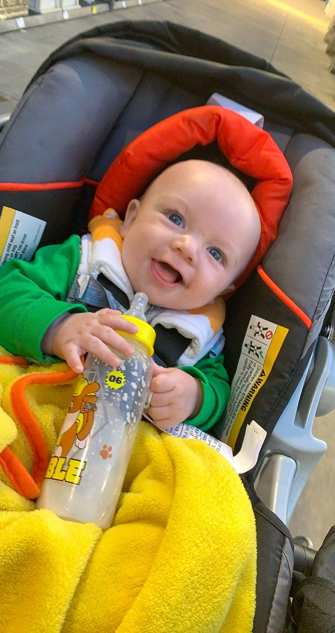 Tracy joined the competition — help win amazing prizes! baby, baby_carriage, baby_products, baby_toddler_clothing, car_seat, child, comfort, eye, facial_expression, fun, happy, lap, orange, people, person, plastic_bottle, seat_belt, sitting, skin, smile