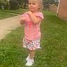Kayliah joined the competition — help win amazing prizes! toddler, child, grass, outdoor, pink_shirt, butterfly, shorts, sneakers, sidewalk, residential, house, greenery, summer, daytime, curious, standing, casual, young_child, nature, suburb