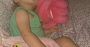 Kayliah joined the competition — help win amazing prizes! toddler, sleeping, blanket, plush_toy, pink, green_clothing, child, indoor, nap, comfort, couch, patterned_fabric, peaceful, soft_toy, rest, young_child, furniture, cozy, cute, relaxation