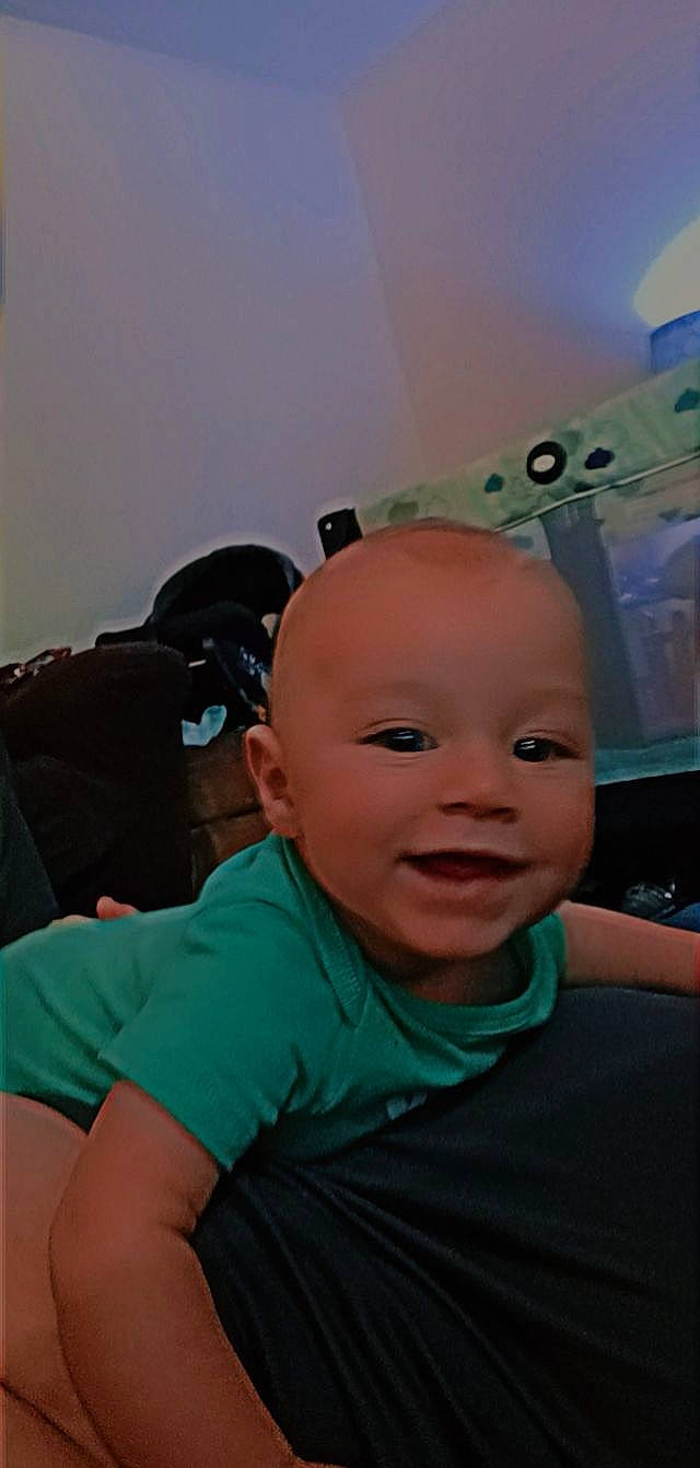 Bhodie is registered to the contest to win money with this photo: baby, baby_products, buzz_cut, ceiling, chair, cheek, child, cloud, comfort, eyebrow, flooring, forehead, fun, happy, person, personal_protective_equipment, room, sitting, smile, t_shirt