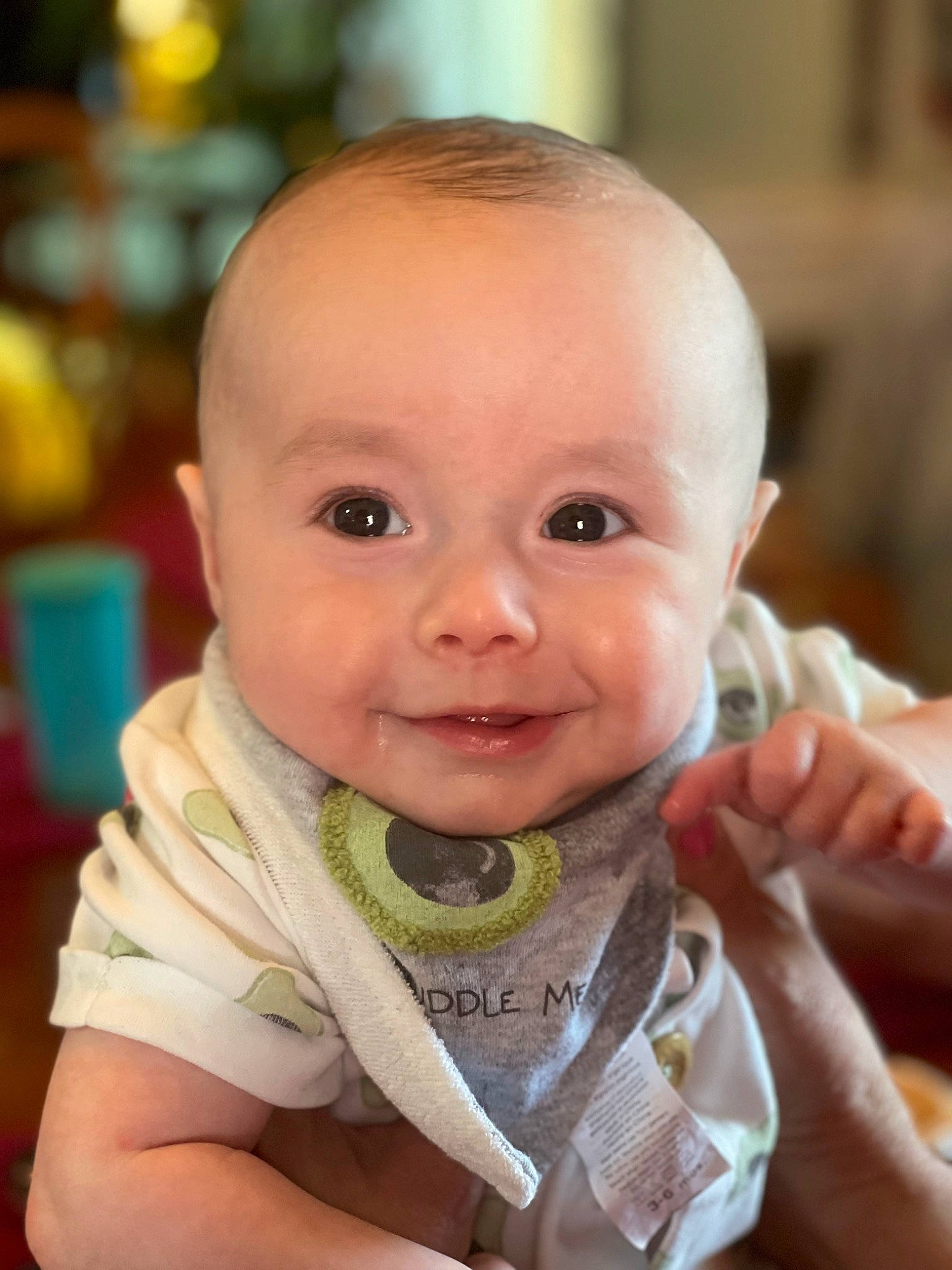 Archer is registered to the contest to win money with this photo: baby, baby_toddler_clothing, cheek, child, chin, dress, ear, finger, fun, gesture, happy, iris, lip, mouth, nose, person, sitting, skin, sleeve, smile