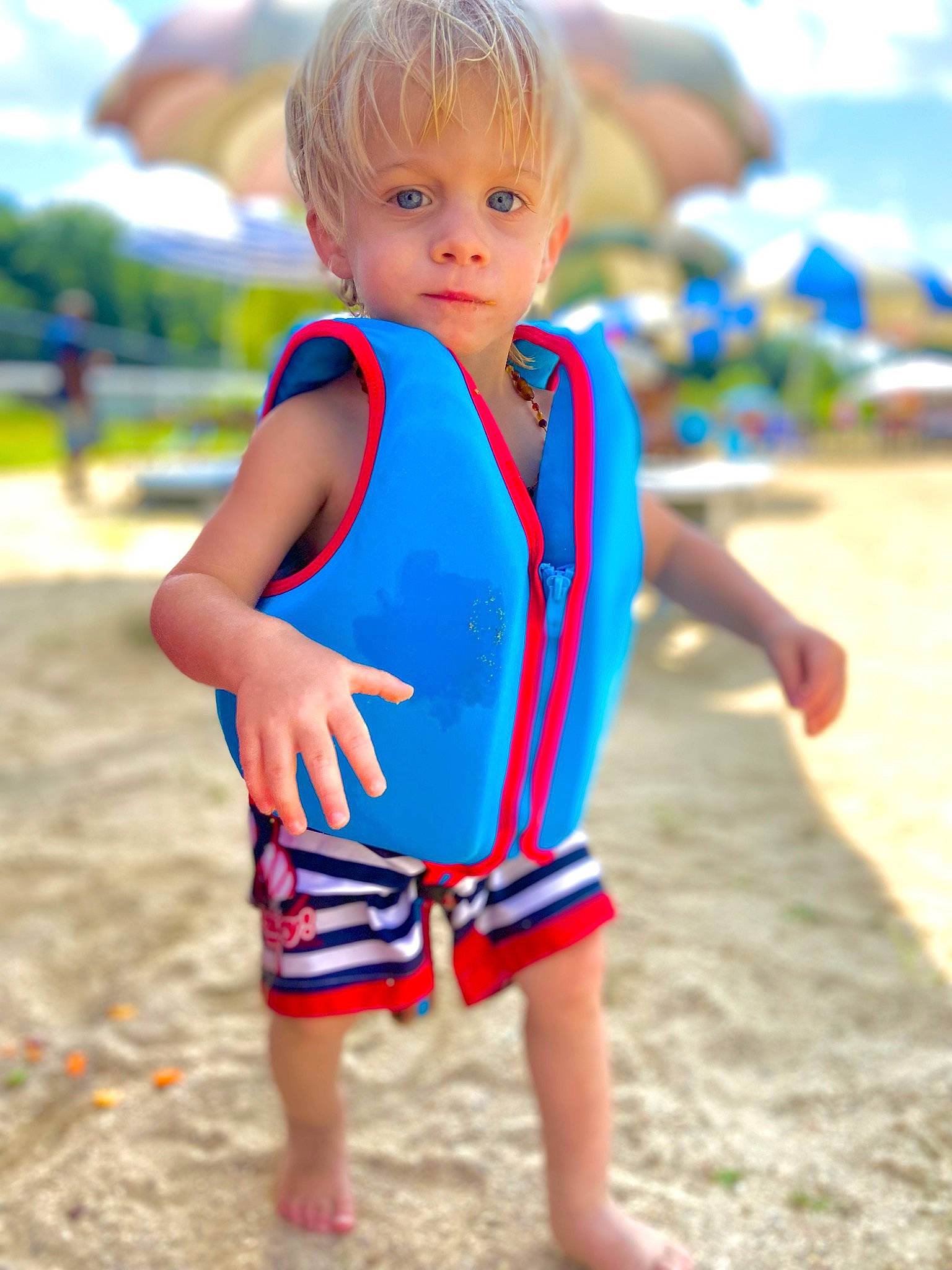 Jameson is registered to the contest to win money with this photo: azure, baby_toddler_clothing, barefoot, beach, child, electric_blue, fun, grass, happy, leisure, people_in_nature, people_on_beach, person, personal_protective_equipment, recreation, sand, sleeve, summer, t_shirt, toddler