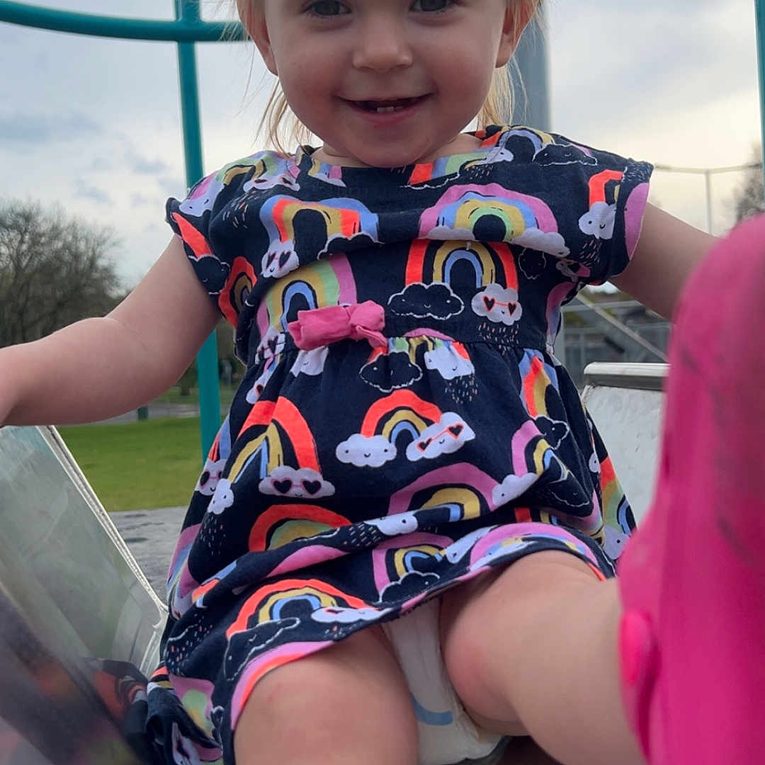 Ameliya joined the competition — help win amazing prizes! baby, clothing, coat, dress, face, grass, head, nature, outdoorplayarea, outdoors, park, person, photography, plant, playarea, portrait, shorts, slide, t_shirt, toy