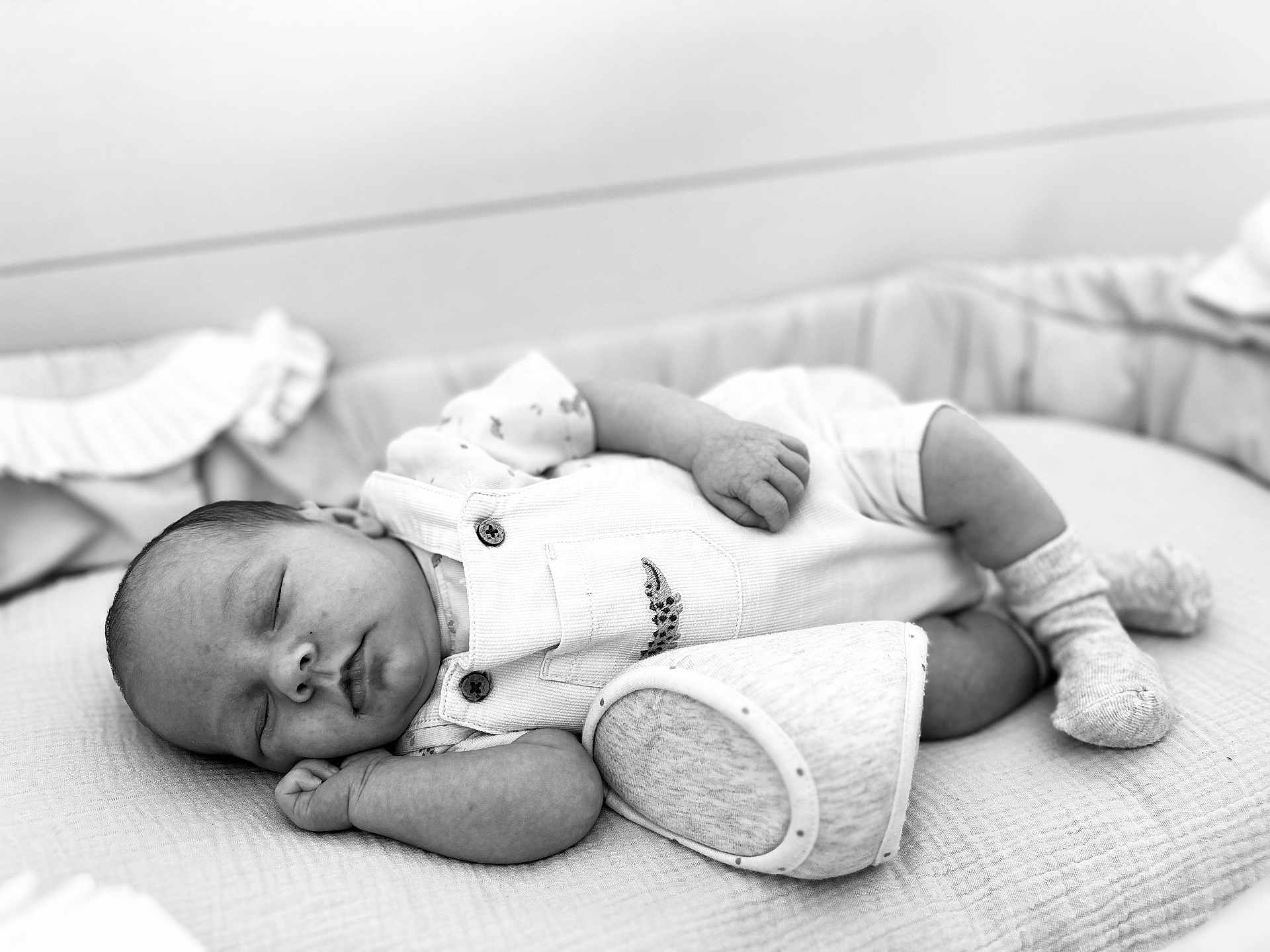Easton participe au concours pour gagner de l'argent avec cette photo : baby, sleeping, infant, overalls, socks, crib, blanket, soft, peaceful, resting, monochrome, portrait, child, newborn, cute, cozy, relaxed, indoor, clothing, babywear