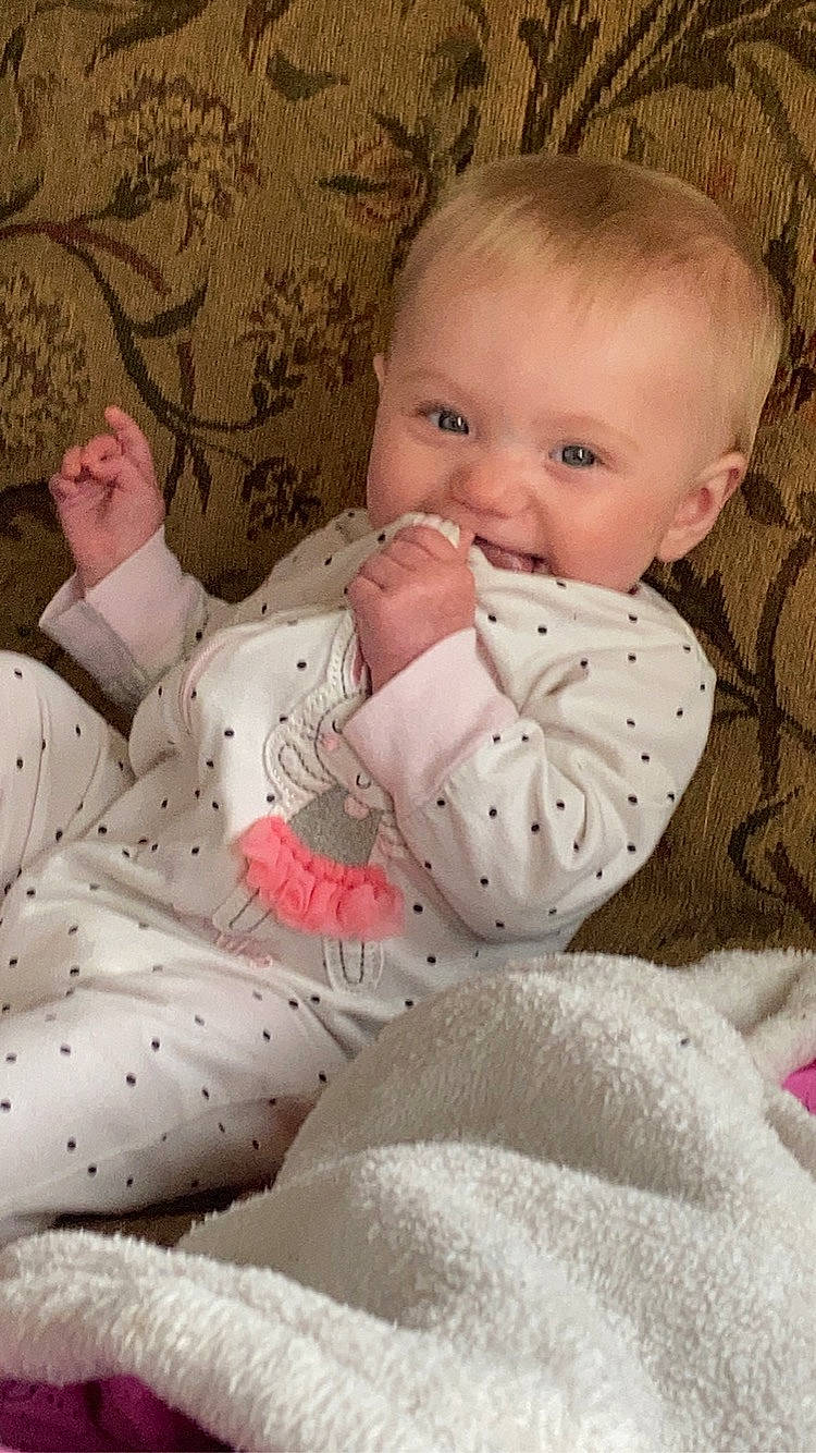 Alexis is registered to the contest to win money with this photo: arm, baby, baby_products, baby_sleeping, baby_toddler_clothing, cheek, child, comfort, eye, head, human_body, linens, lip, mouth, pattern, person, pink, skin, sleeve, textile